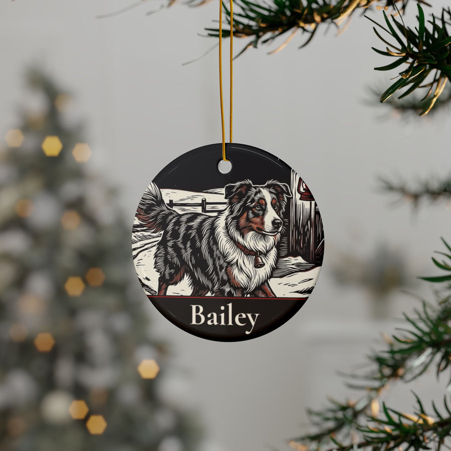 Personalized Australian Shepherd Christmas ornament hanging on a Christmas tree, shown with the sample name Bailey