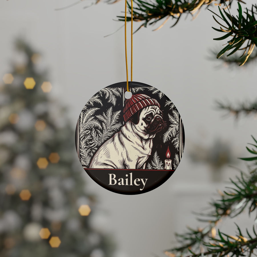 Personalized Pug Christmas ornament hanging on a Christmas tree, shown with the sample name Bailey