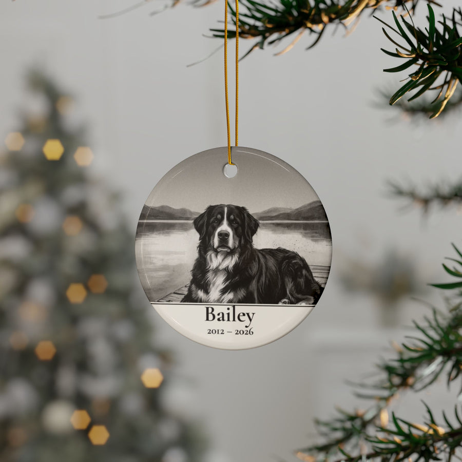 Personalized Bernese Mountain Dog memorial ornament hanging on a Christmas tree, shown with the sample name Bailey