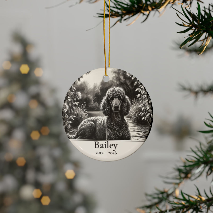 Personalized Poodle memorial ornament hanging on a Christmas tree, shown with the sample name Bailey