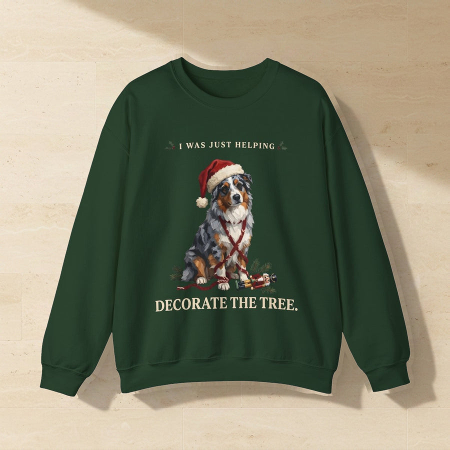 Australian Shepherd Helping Decorate the Tree Crewneck Sweatshirt, Palette Knife Style Holiday Dog Art, Australian Shepherd Lover Gift laid flat on a warm limestone surface, shot from overhead