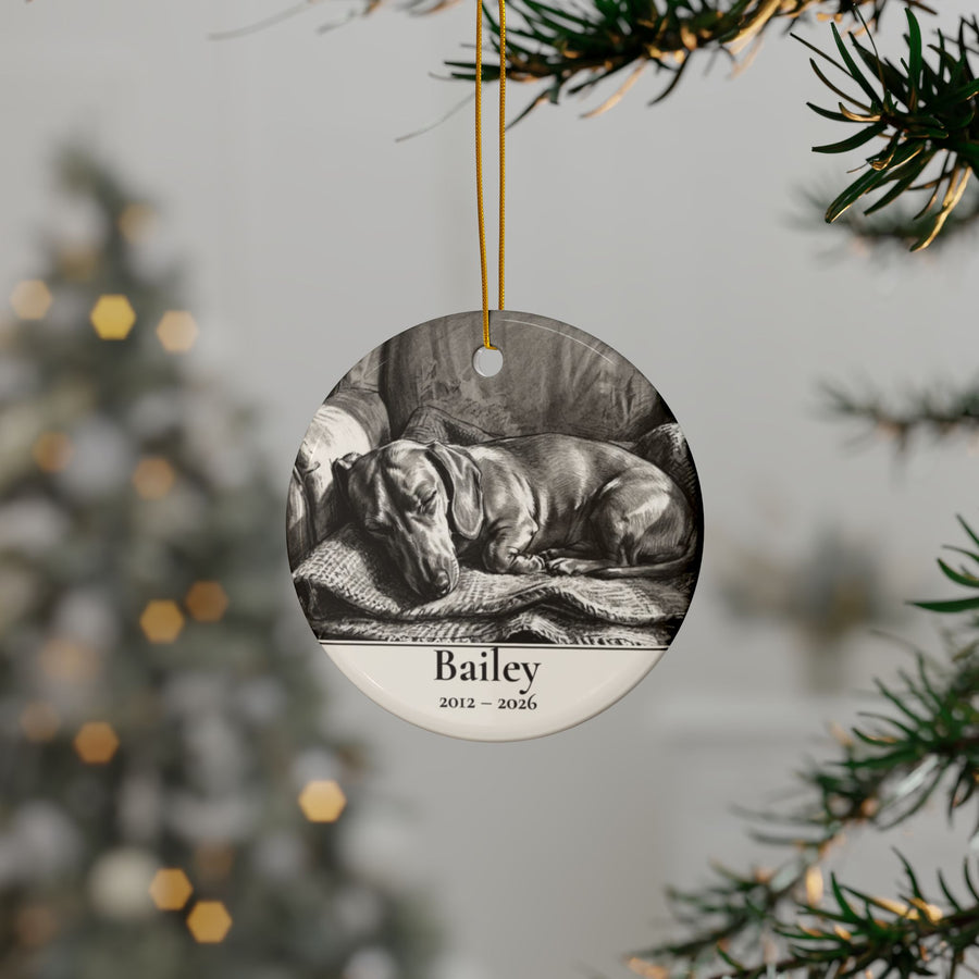 Personalized Dachshund memorial ornament hanging on a Christmas tree, shown with the sample name Bailey