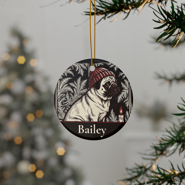 Personalized Pug Christmas ornament hanging on a Christmas tree, shown with the sample name Bailey