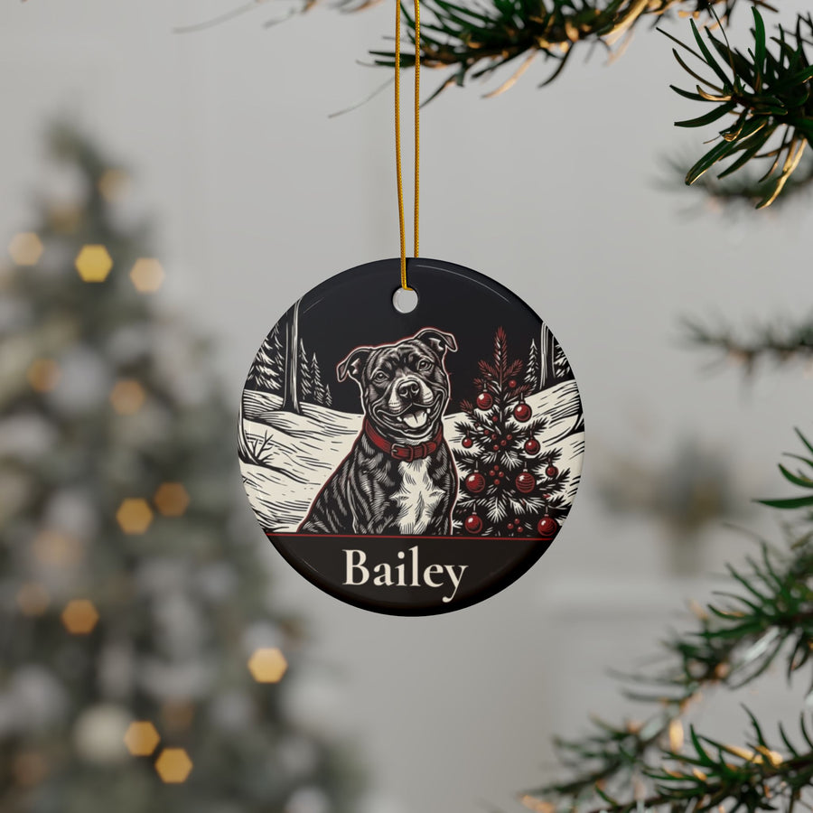 Personalized Staffordshire Bull Terrier Christmas ornament hanging on a Christmas tree, shown with the sample name Bailey