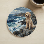 Poodle Acrylic Painting Coastal Cliffside Cork Back Coaster cork coaster shown on a warm limestone surface beside a mug