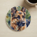 German Shepherd Watercolor Garden Peek Cork Back Coaster cork coaster shown on a warm limestone surface beside a mug