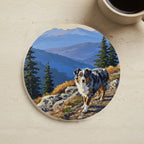 Acrylic Painting Australian Shepherd - Mountain Overlook cork coaster shown on a warm limestone surface beside a mug