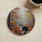 Acrylic Painting Border Collie - Autumn Woods cork coaster shown on a warm limestone surface beside a mug