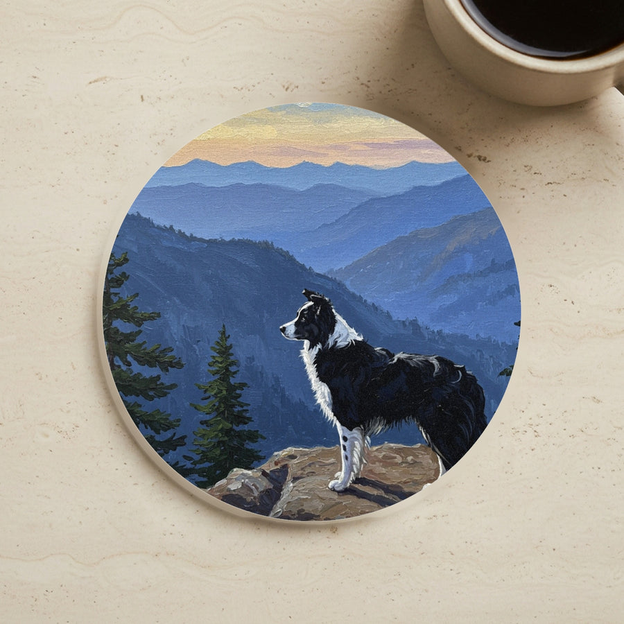 Acrylic Painting Border Collie - Mountain Overlook cork coaster shown on a warm limestone surface beside a mug