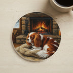 Acrylic Painting Cavalier King Charles Spaniel - Winter Hearth cork coaster shown on a warm limestone surface beside a mug