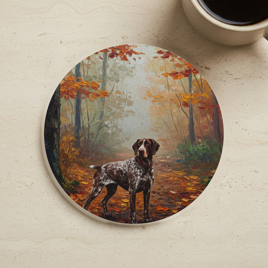 Acrylic Painting German Shorthaired Pointer - Autumn Woods cork coaster shown on a warm limestone surface beside a mug