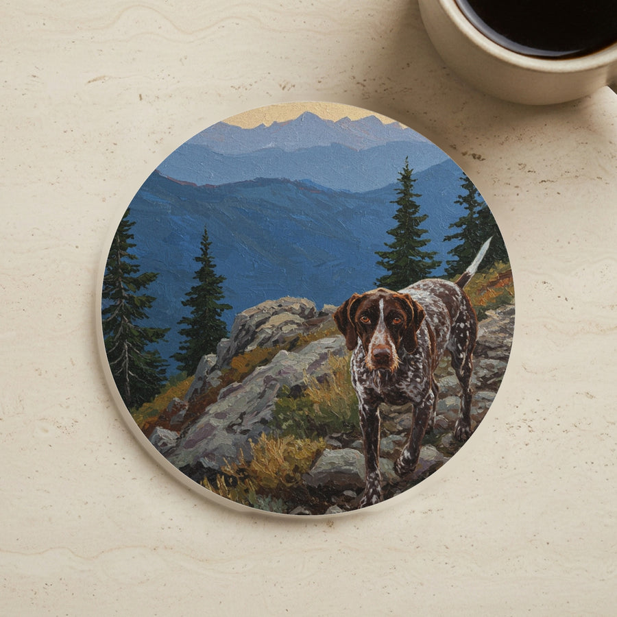 Acrylic Painting German Shorthaired Pointer - Mountain Overlook cork coaster shown on a warm limestone surface beside a mug