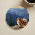Acrylic Painting Pomeranian - Mountain Overlook cork coaster shown on a warm limestone surface beside a mug