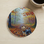 Acrylic Painting Yorkshire Terrier - Autumn Woods cork coaster shown on a warm limestone surface beside a mug
