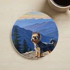 Acrylic Painting Yorkshire Terrier - Mountain Overlook cork coaster shown on a warm limestone surface beside a mug