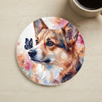 Corgi Watercolor Butterfly Bloom Drink Coaster cork coaster shown on a warm limestone surface beside a mug