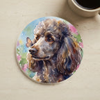 Poodle Watercolor Butterfly Bloom Drink Coaster cork coaster shown on a warm limestone surface beside a mug