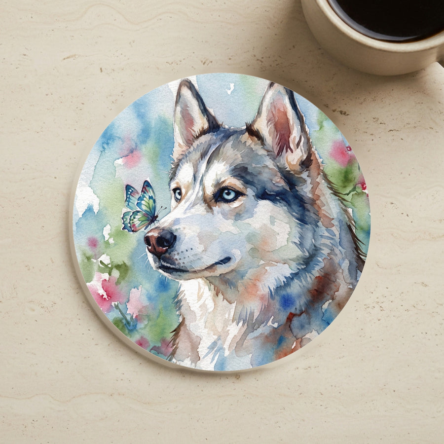 Siberian Husky Watercolor Butterfly Bloom Drink Coaster cork coaster shown on a warm limestone surface beside a mug