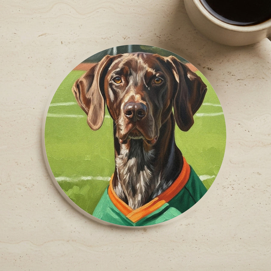 German Shorthaired Pointer Coaster cork coaster shown on a warm limestone surface beside a mug