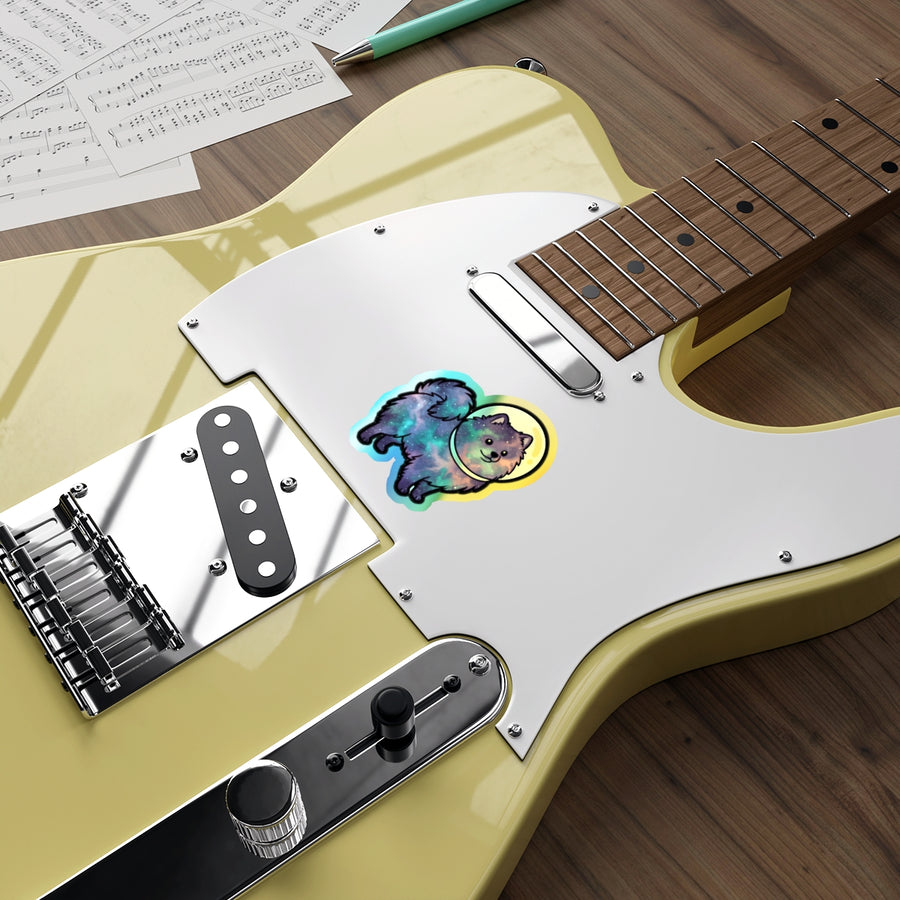Pomeranian Cosmic vinyl sticker by Tritan, on a guitar