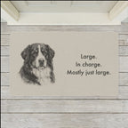 Bernese Mountain Dog Doormat shown flat on a pale painted porch outside a white front door