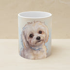 Maltese — Painted Portrait Mug (Style B, Front + Back) shown on a warm limestone shelf, front view