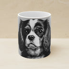 Cavalier King Charles Spaniel Charcoal Portrait Ceramic Mug 11oz shown on a warm limestone shelf, front view