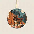 French Bulldog Halloween Poster Ceramic Tree Ornament round ceramic ornament by Tritan, laid flat on a warm limestone surface