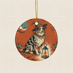 Australian Shepherd Halloween Poster Ceramic Tree Ornament round ceramic ornament by Tritan, laid flat on a warm limestone surface