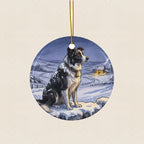 Border Collie Christmas Storybook Ceramic Tree Ornament round ceramic ornament by Tritan, laid flat on a warm limestone surface