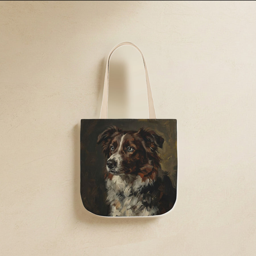 Border Collie Tote Bag canvas tote bag hanging by its handles against a warm limestone wall