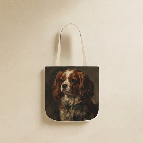Cavalier King Charles Spaniel Tote Bag canvas tote bag hanging by its handles against a warm limestone wall