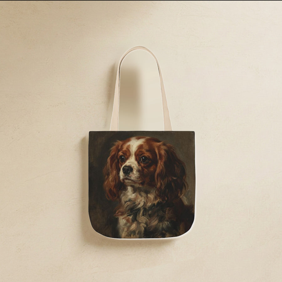 Cavalier King Charles Spaniel Tote Bag canvas tote bag hanging by its handles against a warm limestone wall