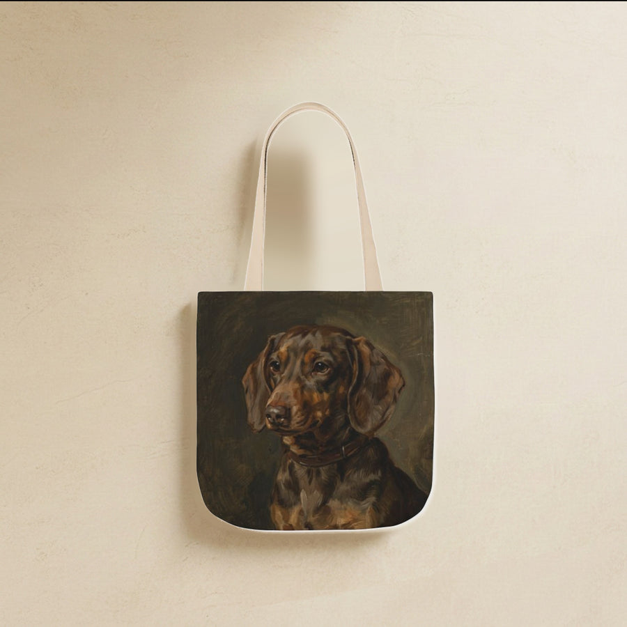 Dachshund Tote Bag canvas tote bag hanging by its handles against a warm limestone wall