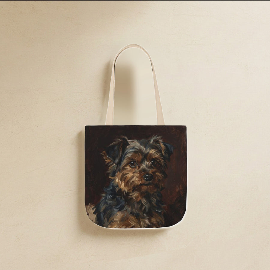 Yorkshire Terrier Tote Bag canvas tote bag hanging by its handles against a warm limestone wall