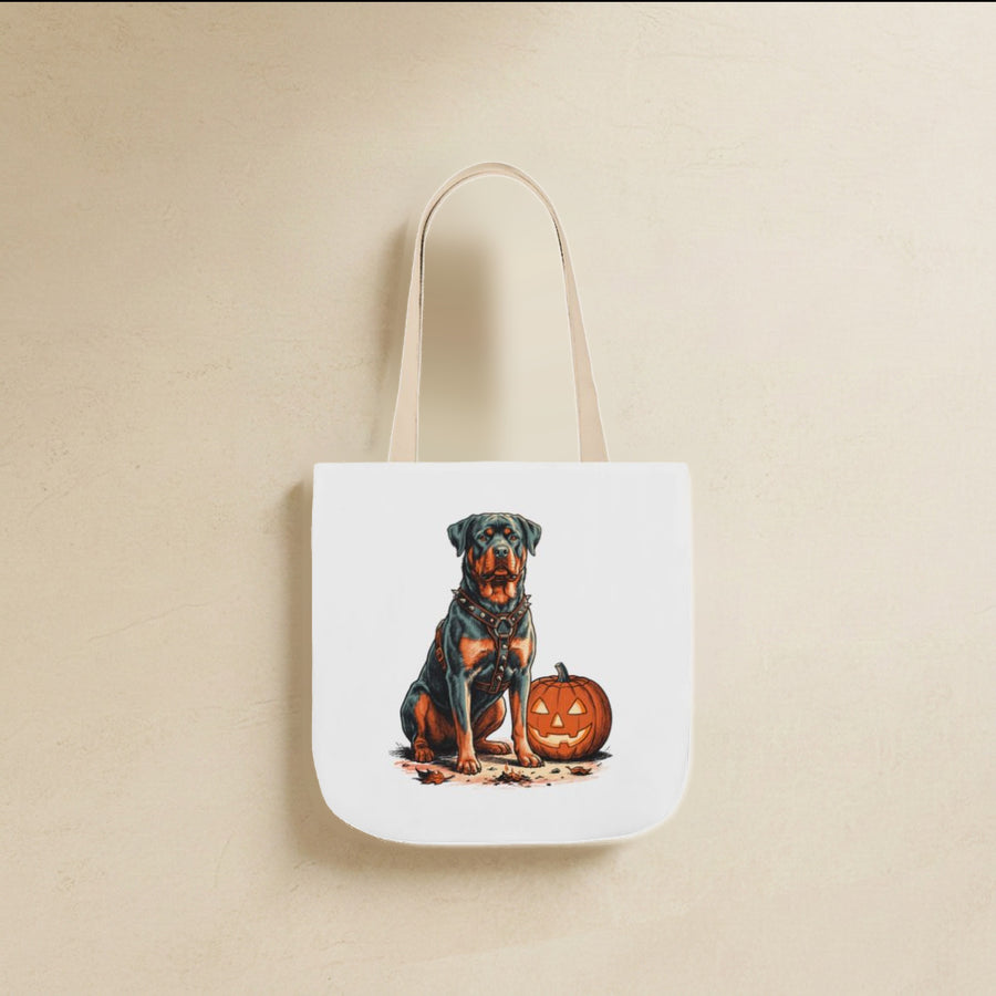 Rottweiler Halloween Tote Bag canvas tote bag hanging by its handles against a warm limestone wall