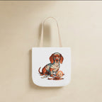 Dachshund Halloween Tote Bag canvas tote bag hanging by its handles against a warm limestone wall