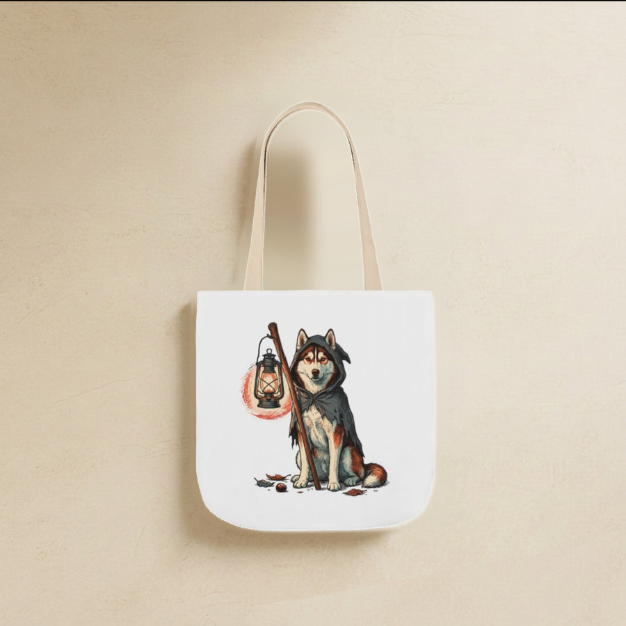 Husky Halloween Tote Bag canvas tote bag hanging by its handles against a warm limestone wall