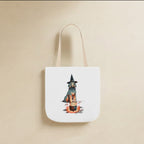 Poodle Halloween Tote Bag canvas tote bag hanging by its handles against a warm limestone wall